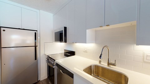 a kitchen with a sink and a refrigerator